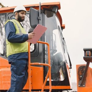 indian-man-working-male-yellow-vest-man-near-tractor-scaled (1)